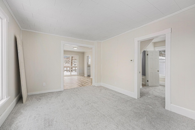 carpeted spare room with crown molding