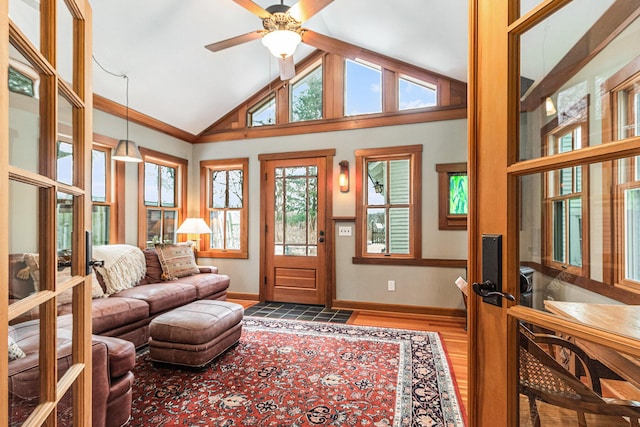 interior space featuring ceiling fan, high vaulted ceiling, and wood-type flooring