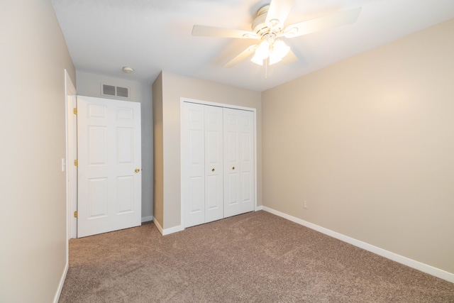 unfurnished bedroom featuring visible vents, baseboards, ceiling fan, carpet, and a closet