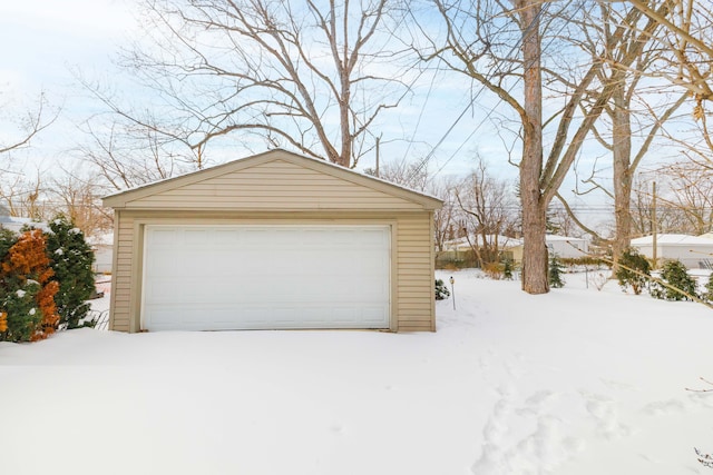 snow covered garage with a garage