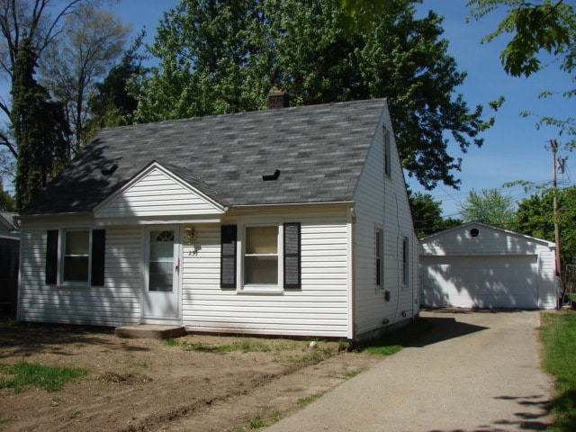 view of front of home with a garage and an outdoor structure