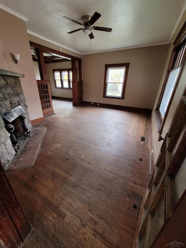 unfurnished living room with ornamental molding, visible vents, and wood finished floors