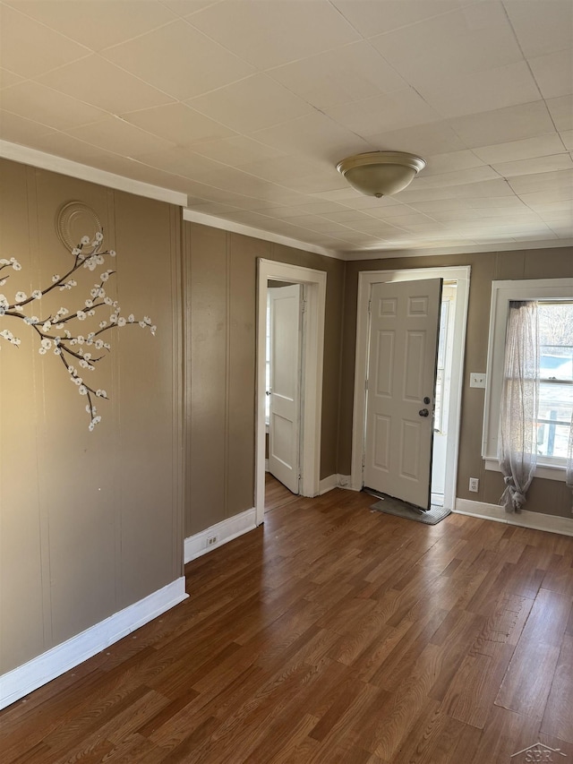 entrance foyer featuring dark wood-style flooring and baseboards