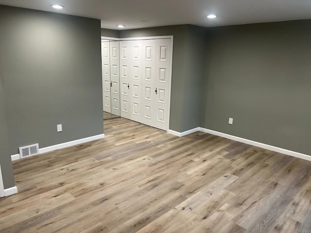 unfurnished bedroom featuring light wood-type flooring and a closet