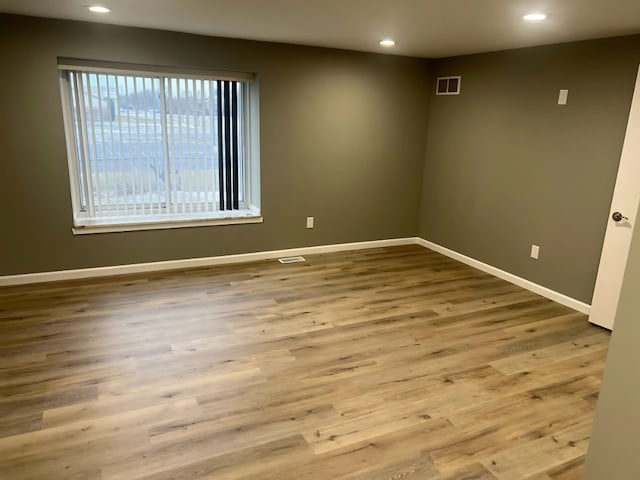 empty room with light hardwood / wood-style floors