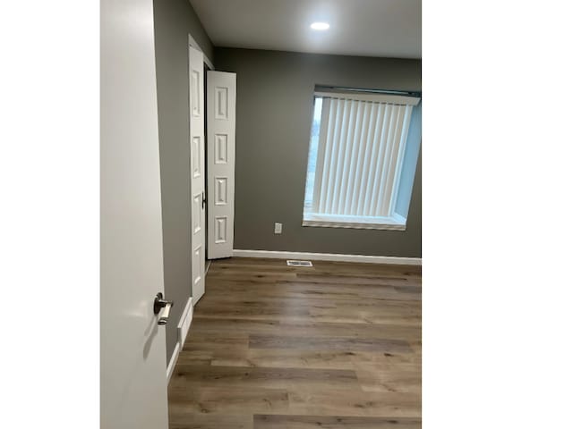 spare room with hardwood / wood-style floors