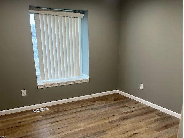 empty room with light hardwood / wood-style flooring