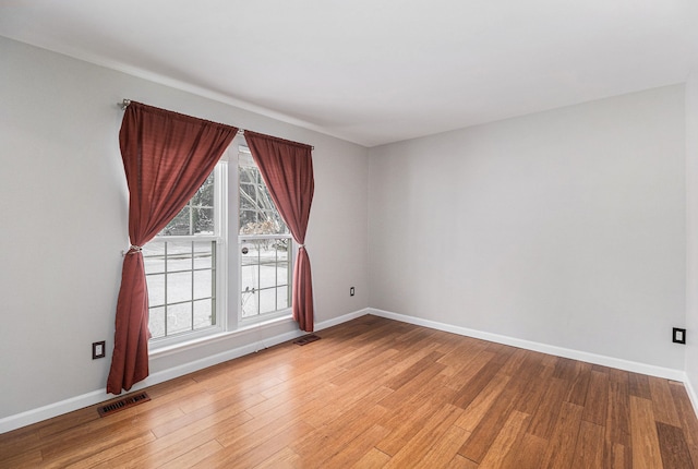 empty room with light hardwood / wood-style floors