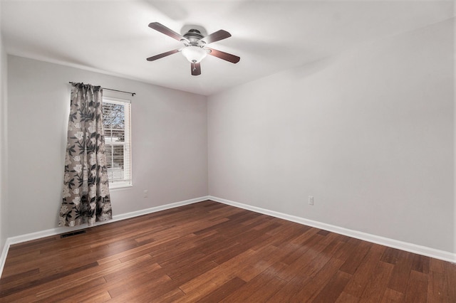 spare room with ceiling fan and dark hardwood / wood-style floors