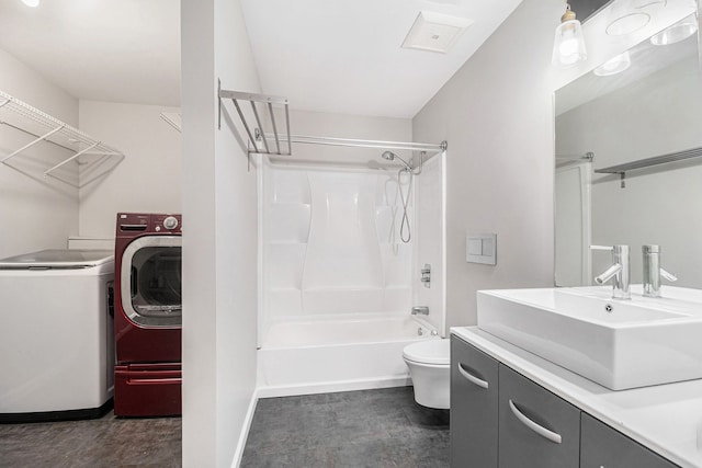 full bathroom featuring shower / bath combination, washer / clothes dryer, vanity, and toilet