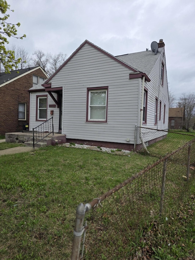 20529 Irvington St, Highland Park, MI 48203 - exterior space with a yard, a chimney, and a fenced backyard