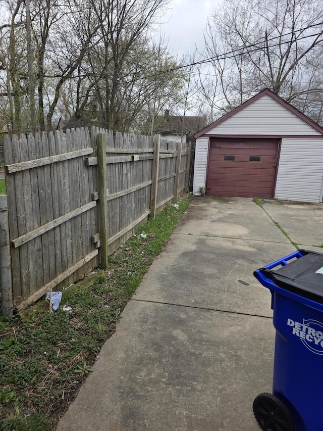 20529 Irvington St, Highland Park, MI 48203 - exterior space featuring concrete driveway, an outdoor structure, fence, and a detached garage