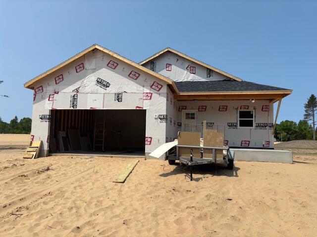 6241 Sturgeon Run, Muskegon, MI 49444 - property under construction with an attached garage and covered porch