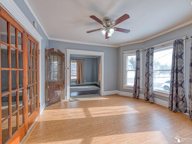 unfurnished room with ceiling fan, ornamental molding, light wood-type flooring, and french doors