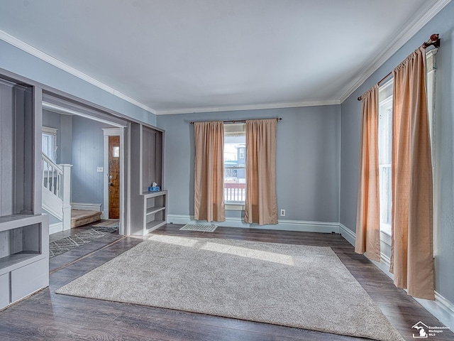 spare room featuring crown molding and dark hardwood / wood-style flooring