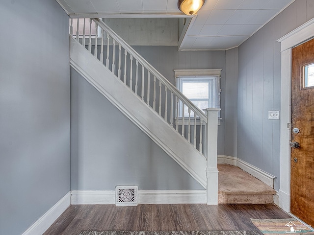 stairs featuring hardwood / wood-style floors