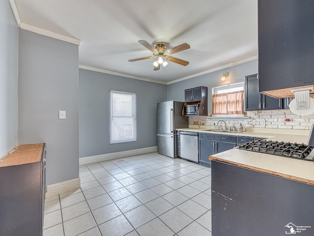 kitchen with appliances with stainless steel finishes, decorative backsplash, crown molding, light tile patterned floors, and sink