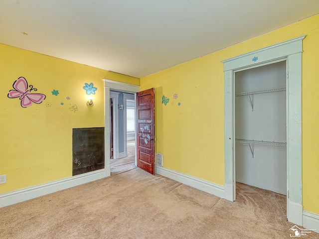 unfurnished bedroom with carpet and a closet