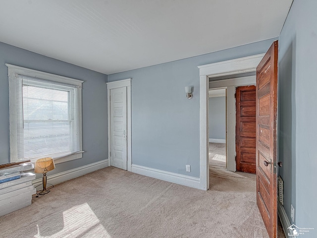 unfurnished bedroom with light carpet