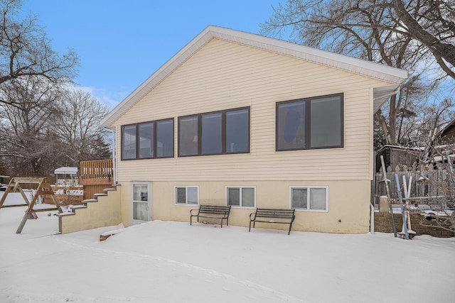 snow covered property featuring a deck