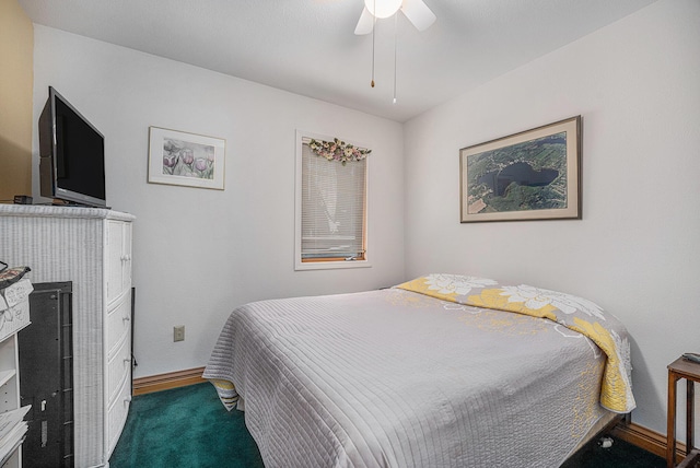 bedroom featuring a fireplace, carpet flooring, and ceiling fan