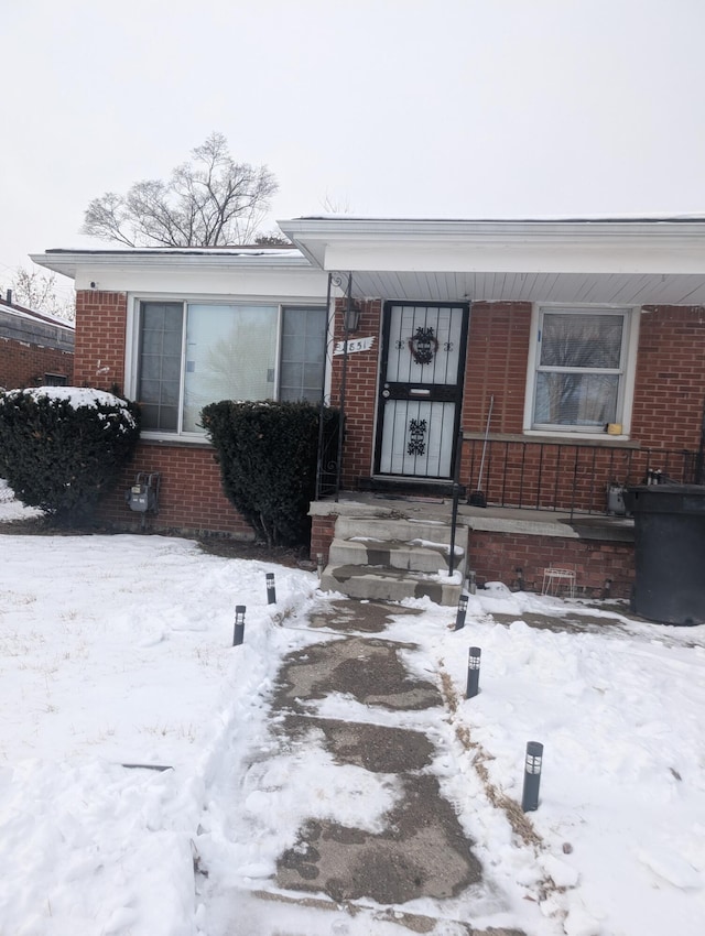 view of snow covered property entrance