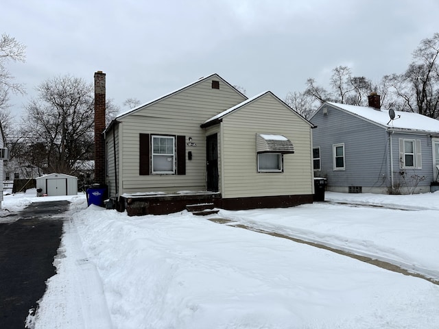 view of front of home featuring a shed