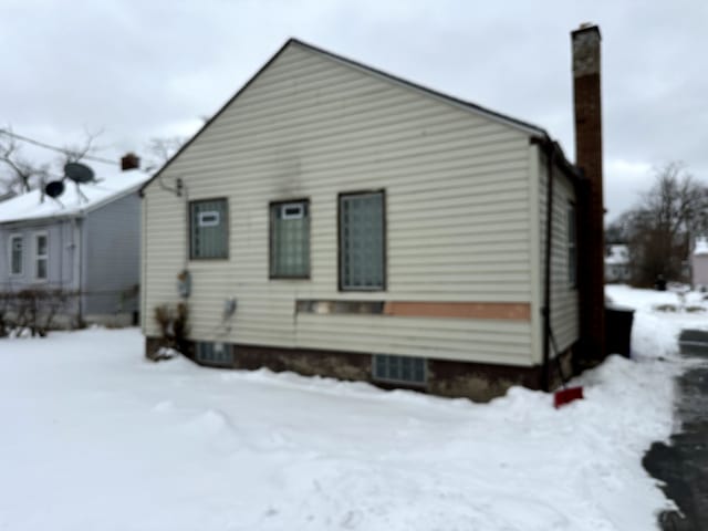 view of snow covered rear of property