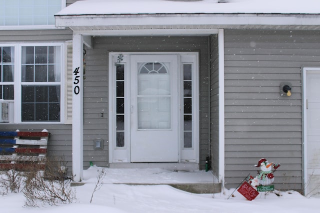 view of snow covered property entrance