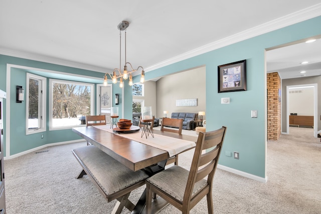 dining area with a healthy amount of sunlight, light colored carpet, and an inviting chandelier