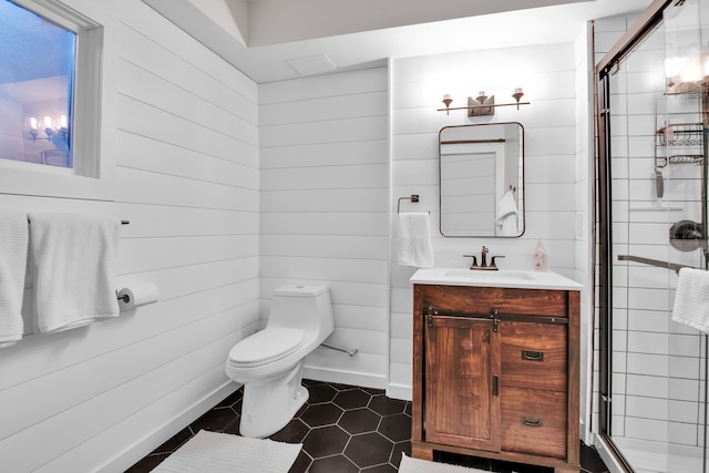 full bath with a stall shower, baseboards, toilet, tile patterned flooring, and vanity