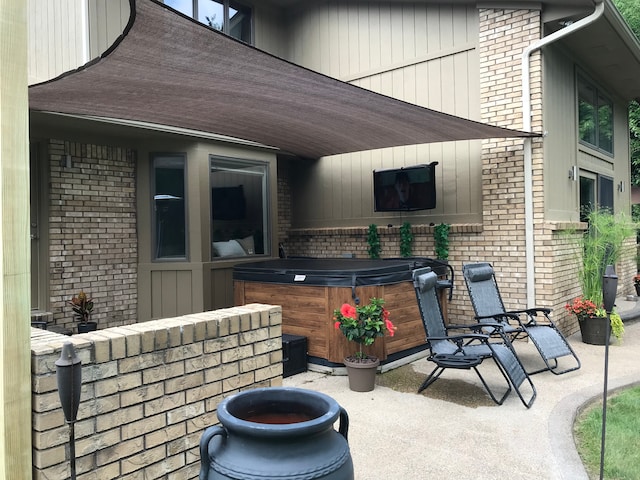 view of patio / terrace with a hot tub