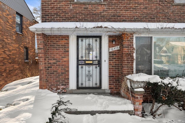 view of snow covered property entrance