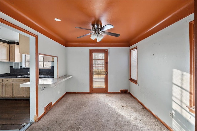 interior space with ceiling fan