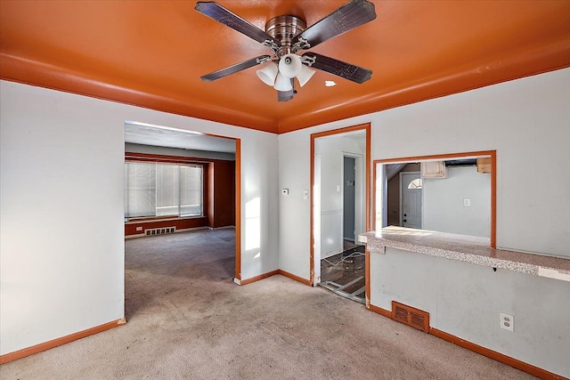 carpeted empty room featuring ceiling fan