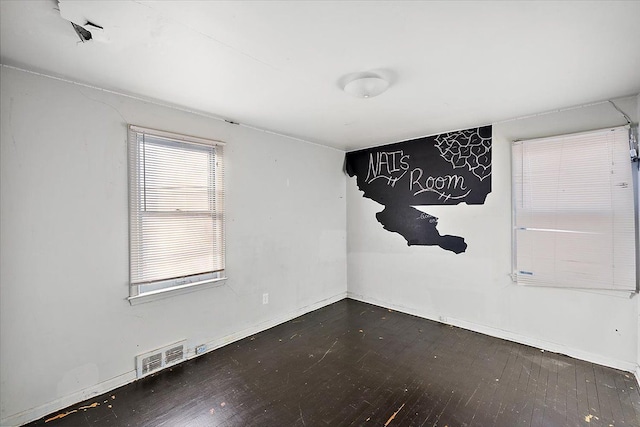 empty room with dark hardwood / wood-style flooring