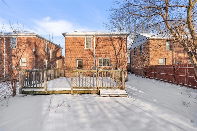 snow covered house with a deck