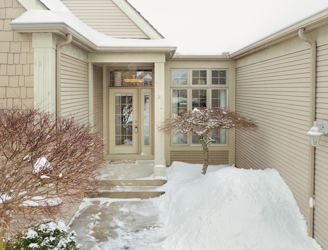 view of snow covered property entrance