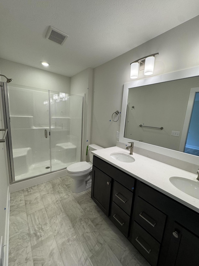 273 Hickory Valley Dr, Kalamazoo, MI 49009 - full bathroom featuring a shower stall, double vanity, toilet, recessed lighting, and a textured ceiling