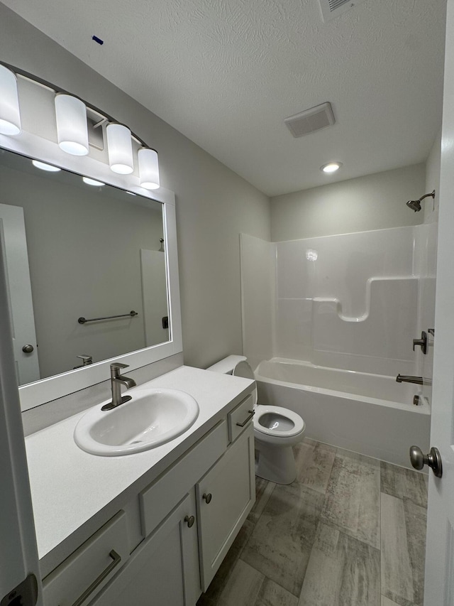 273 Hickory Valley Dr, Kalamazoo, MI 49009 - full bathroom with vanity, toilet, a textured ceiling, and bathtub / shower combination