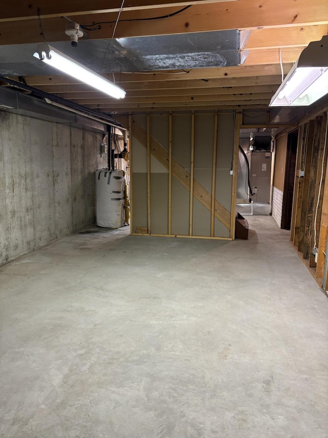 basement featuring heating unit and water heater