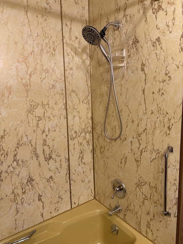 interior details featuring tiled shower / bath combo