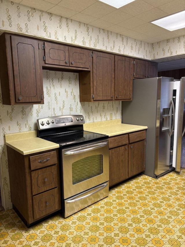 kitchen featuring appliances with stainless steel finishes and dark brown cabinets