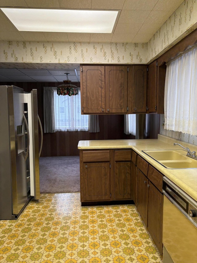 kitchen with sink, dishwasher, stainless steel fridge with ice dispenser, kitchen peninsula, and dark brown cabinets