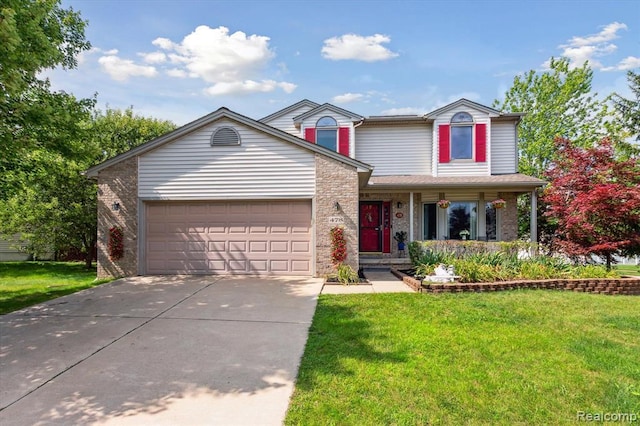 view of property with a front yard and a garage