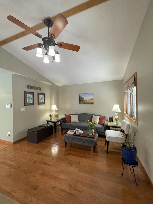 living room with ceiling fan, hardwood / wood-style floors, and lofted ceiling