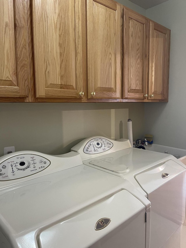 laundry room with cabinets and separate washer and dryer