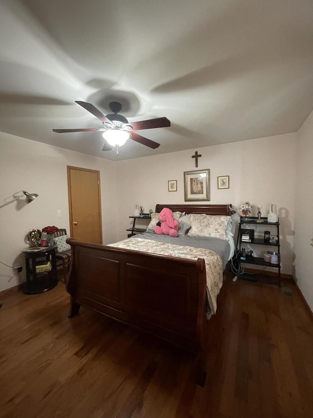 bedroom with dark wood-type flooring and ceiling fan