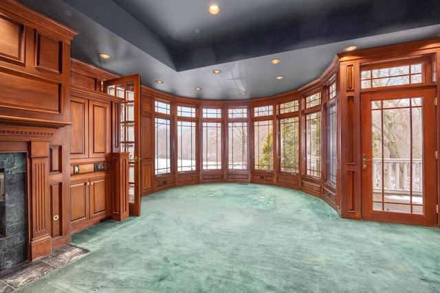 carpeted spare room featuring a fireplace