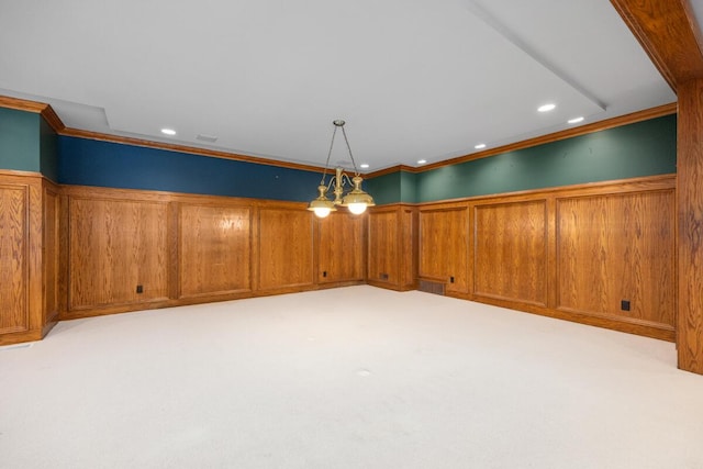 spare room featuring ornamental molding and light carpet